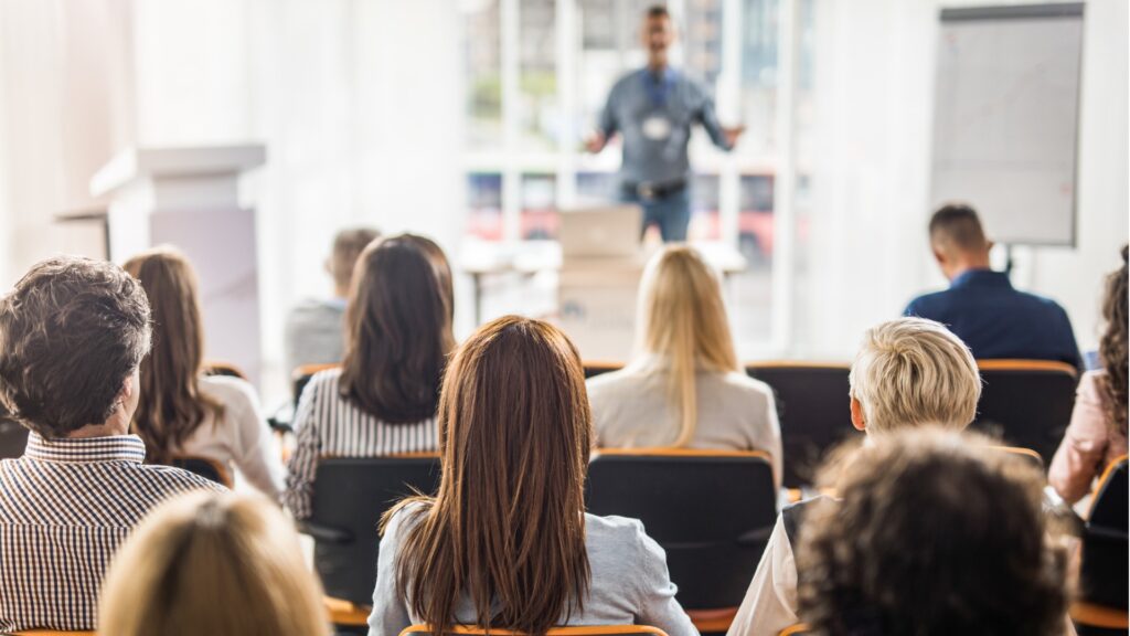 rear view of business people attending a seminar in board room picture id1002018094